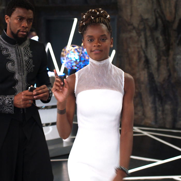 Shuri in a white dress showing T'Challa how brilliant she is.